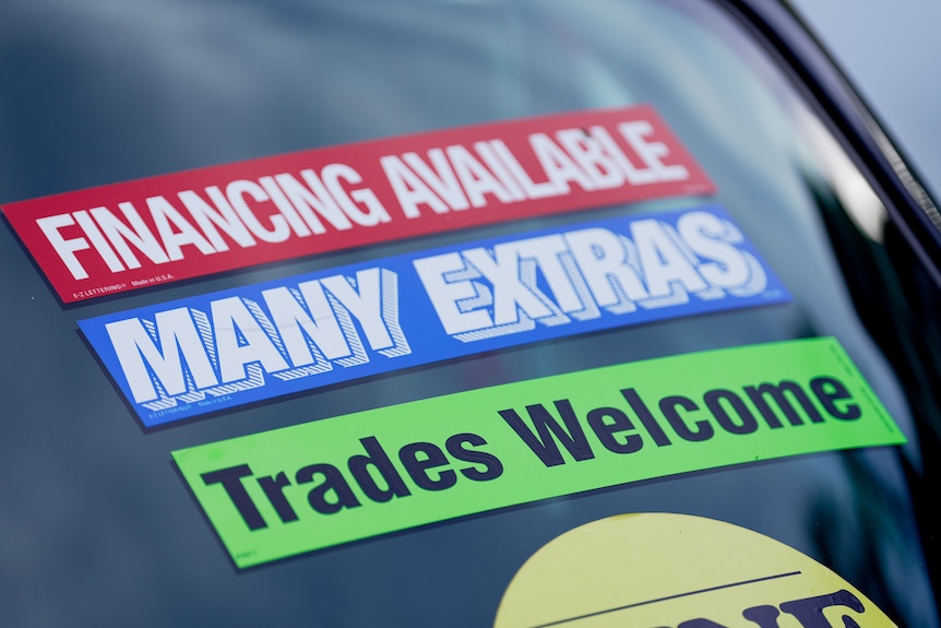Close up of a sticker on a used car saying Financing Available.