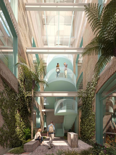The glazed atrium space incorporates lush landscaping and a spiral staircase.