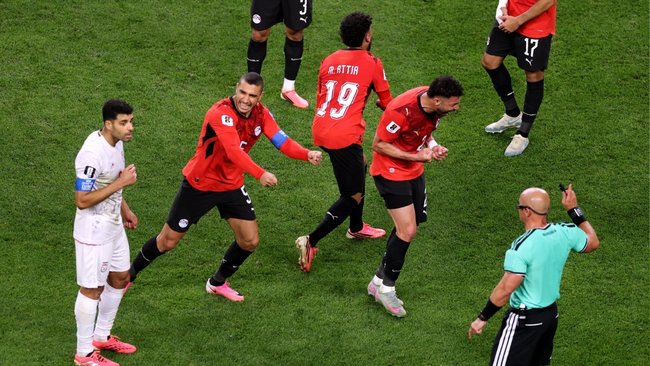 Egypt players celebrate after Iran’s stoppage-time winner was ruled offside.