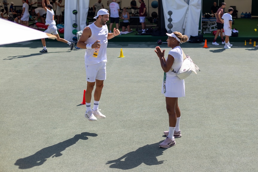 Grigor Dimitrov jumps for joy as he meets Serena Williams at Wimbledon.