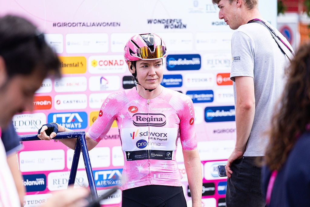 Van der Breggen in the pink jersey descends from the podium