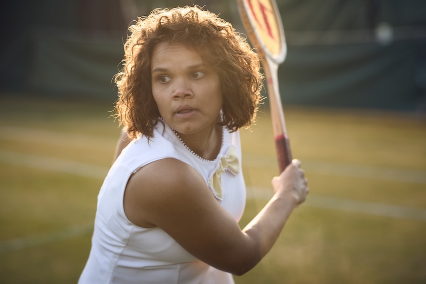 LIla as Evonne takes a swing at a tennise ball during a match.