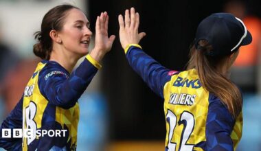 Heather Graham hets a high five from Durham skipper Mady Villers.