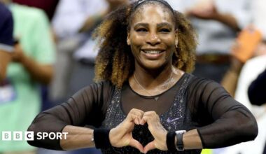 Serena Williams does a heart symbol with her hands while playing at the 2022 US Open