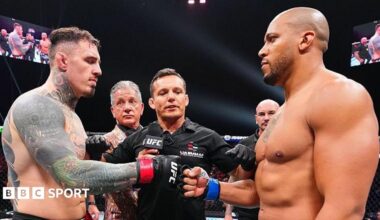 Tom Aspinall and Ciryl Gane touch gloves before their UFC fight in October 2025