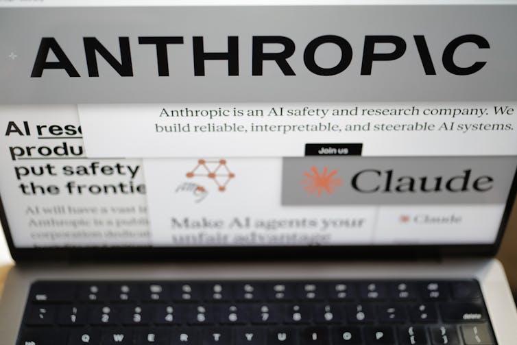 A laptop screen showing the Anthropic logo.