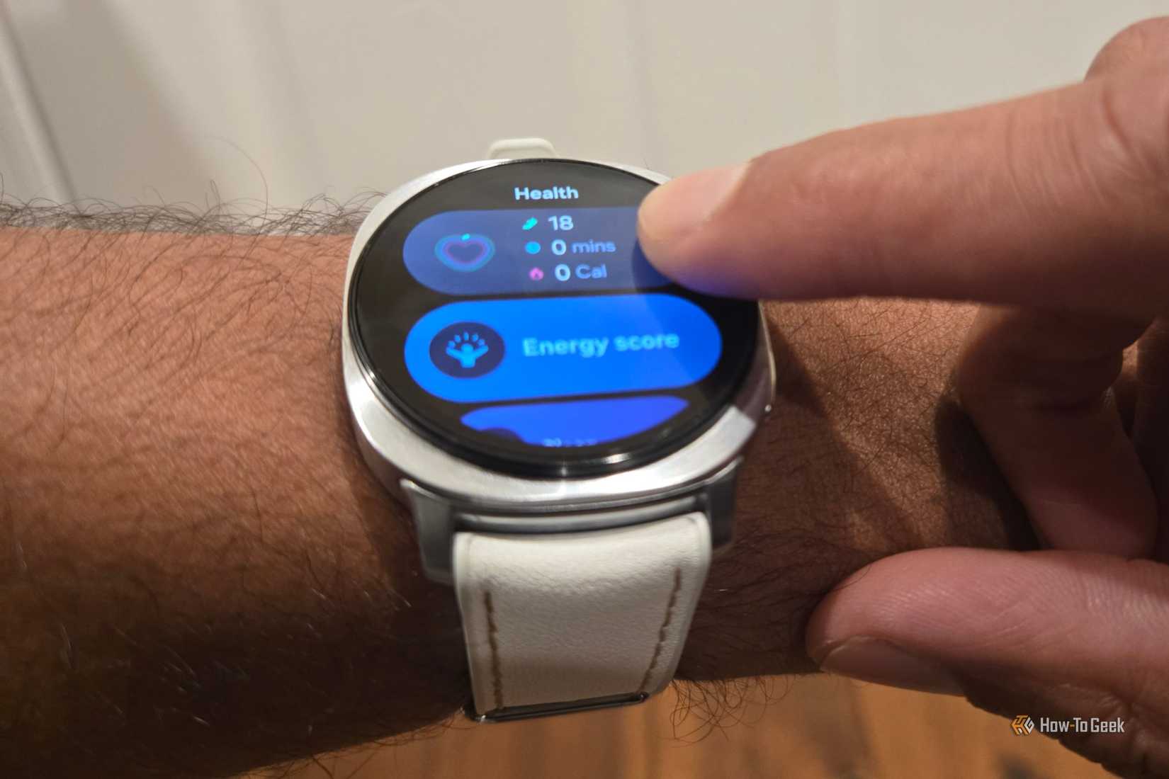Finger tapping the bezel on a Samsung Galaxy Watch 8