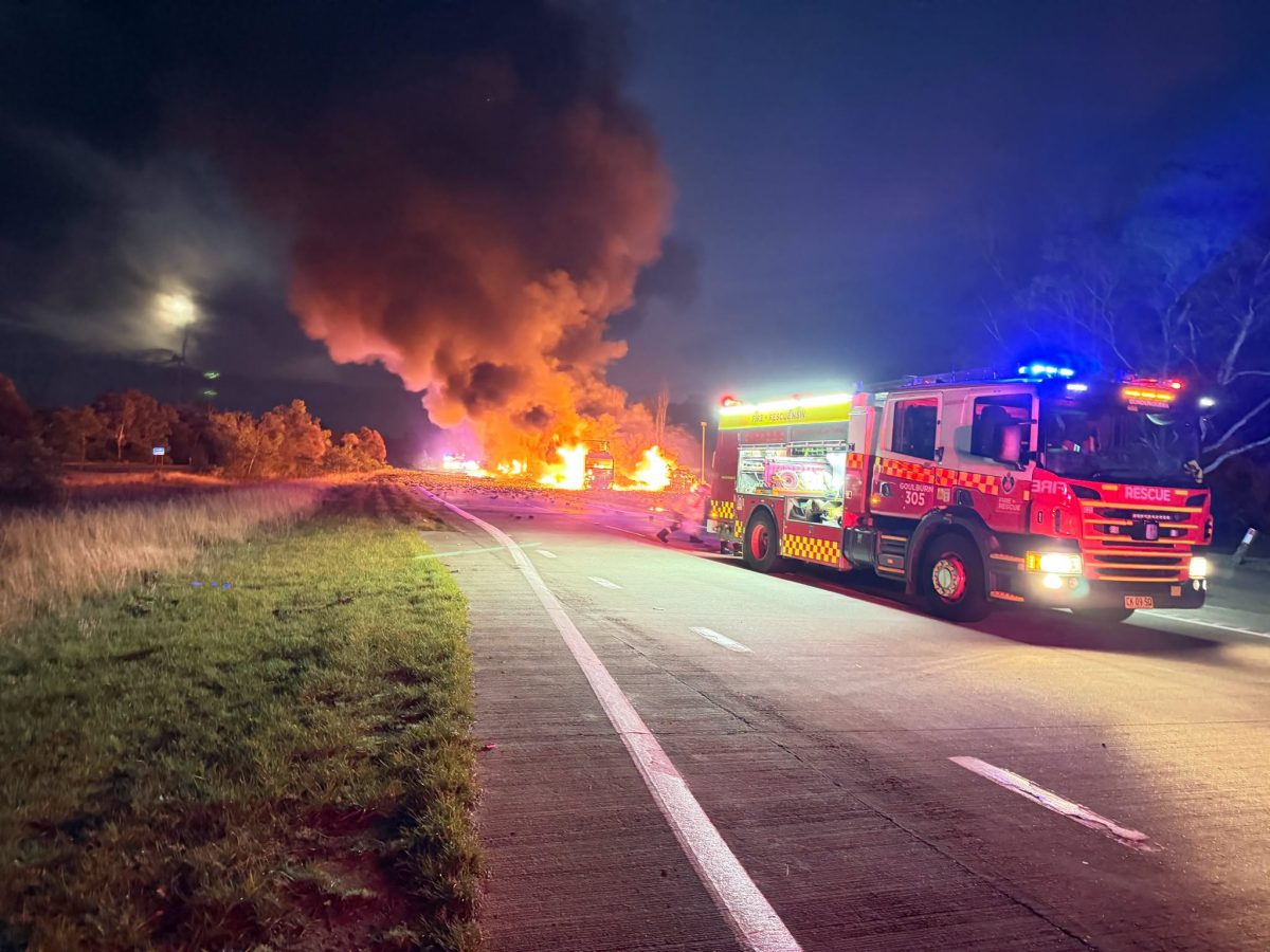fire truck with fire behind it on Hume Highway