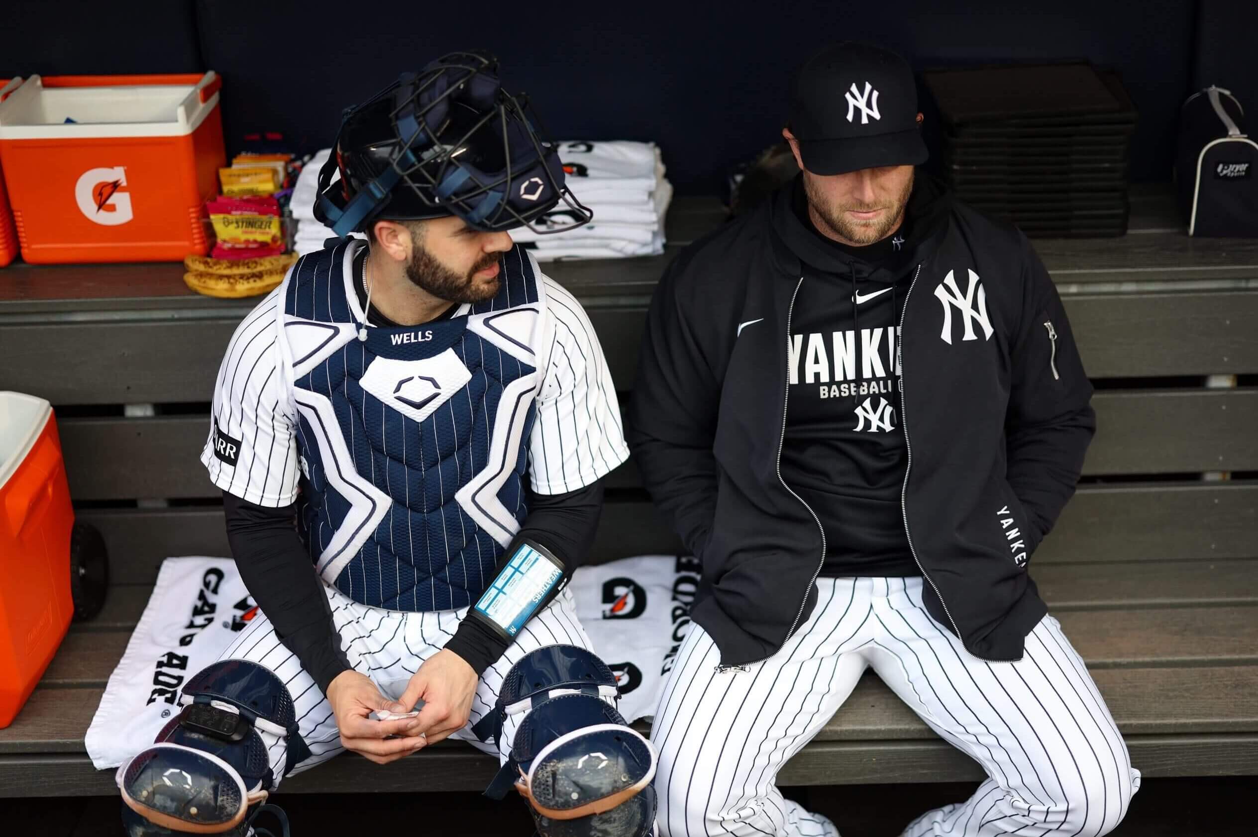 Austin Wells, left, and Gerrit Cole of the New York Yankees talk in the dugout before a game against the Kansas City at Yankee Stadium on April 19, 2026