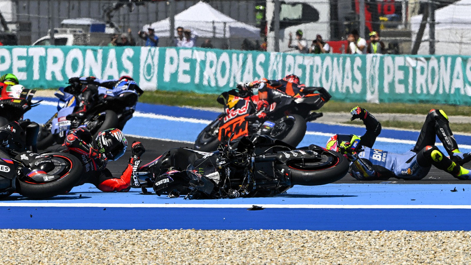 Iker Lecuona rides past while team-mate Fermin Aldeguer is caught up in Turn 1 incident, 2026 Hungarian MotoGP.