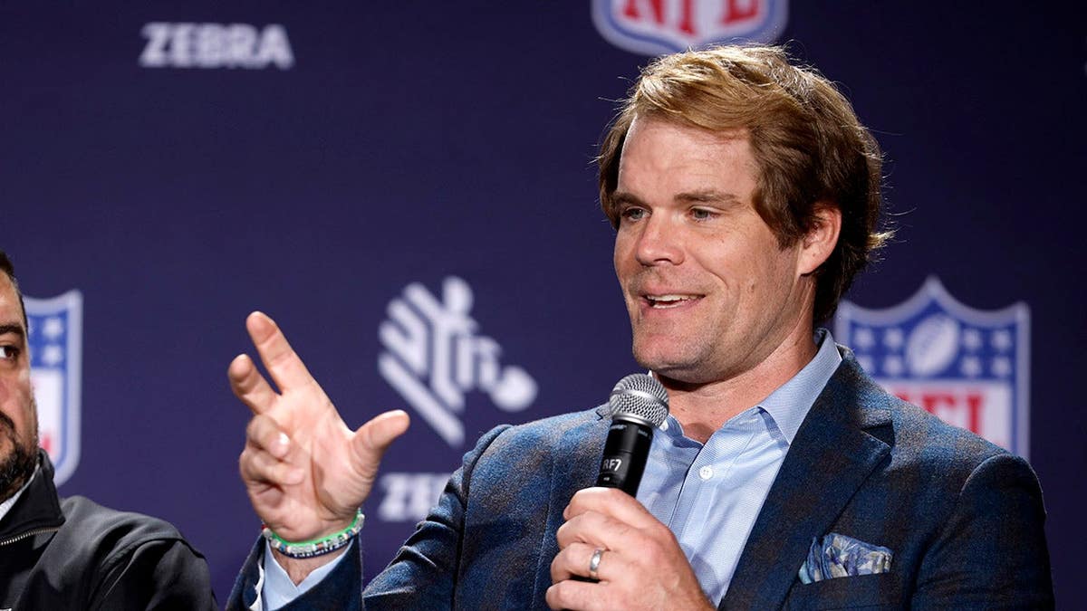 Greg Olsen and Josh Helmrich discussing NFL data technology in New Orleans Louisiana.