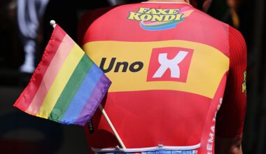 Anders Skaarseth of Norway and Team Uno-X Mobility riders displays an LGBT+ flag prior to the Tour Auvergne-Rhone-Alpes 2026, Stage 8 (Photo by Dario Belingheri/Getty Images)
