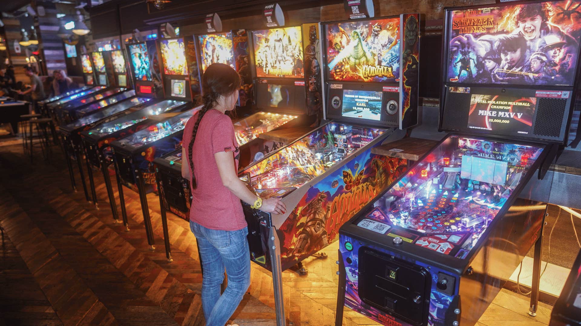 woman playing '80s arcade games to protect her mental health