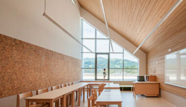 concrete and beech shape flexible learning spaces within school in slovenia