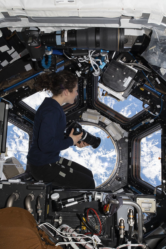 NASA astronaut Christina Koch floating weighlessly in the cupola of the International Space Station