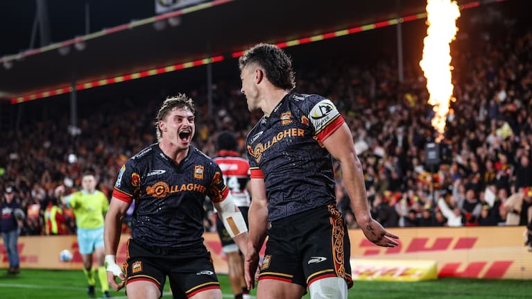 Isaac Hutchison of the Chiefs, left, celebrates a try from Kyren Taumoefolau against the Crusaders.