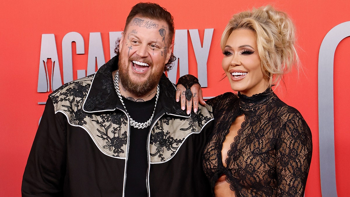 Jelly Roll and Bunnie Xo posing on the red carpet at the ACM Awards