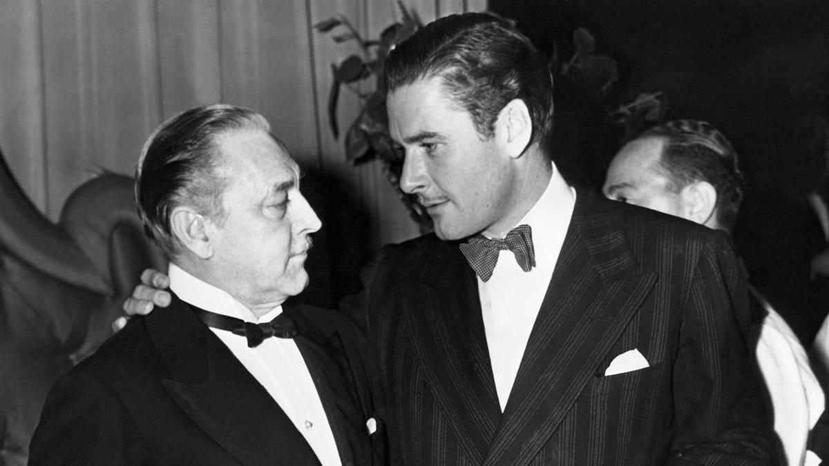 John Barrymore and Errol Flynn standing together