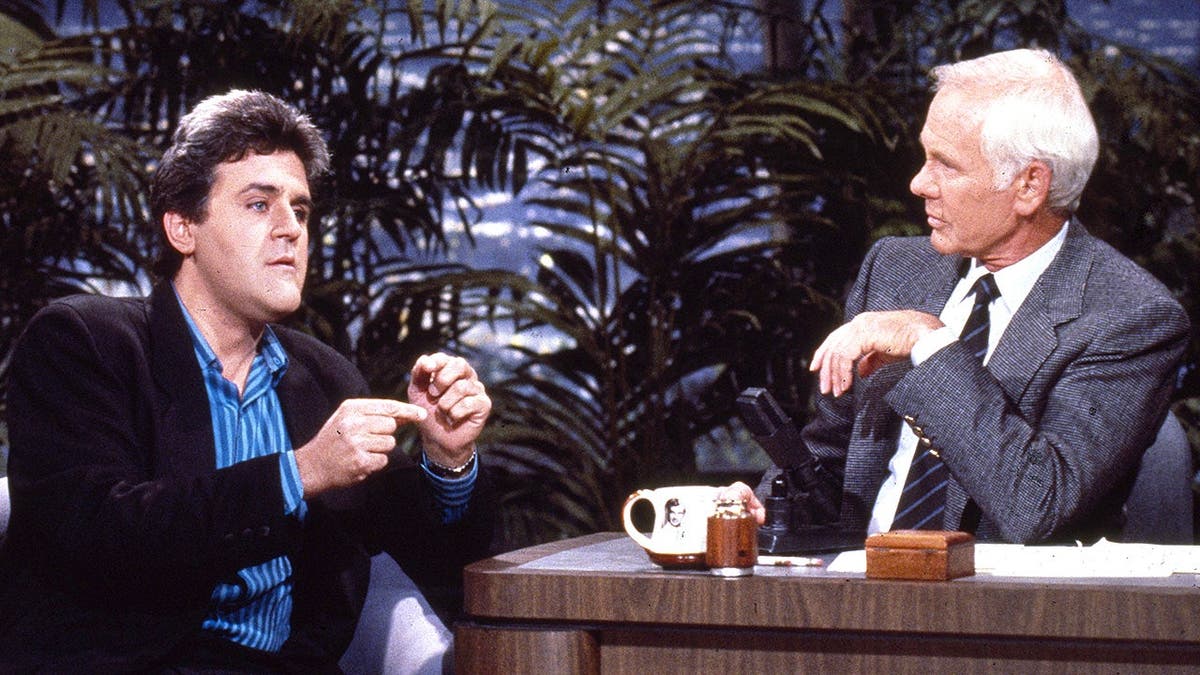 Jay Leno speaks with Johnny Carson during 'Tonight Show' interview.