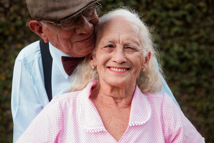 Elderly couple smiling and embracing, representing dementia care support and understanding