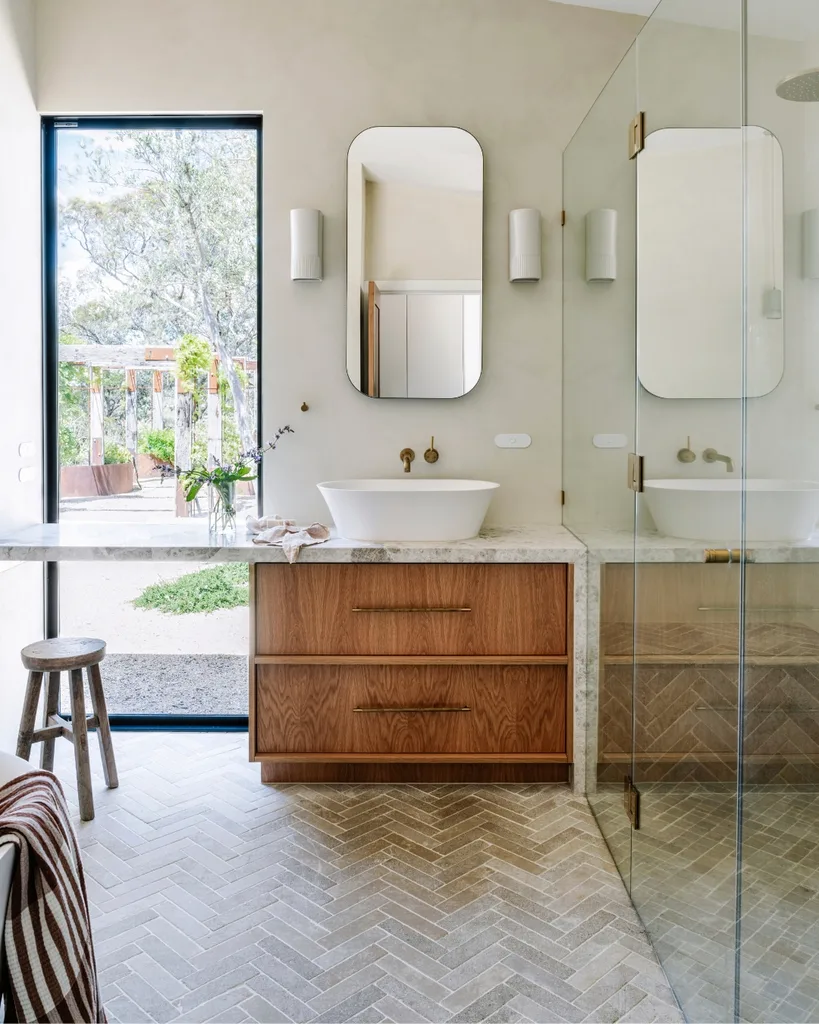 Bright open bathroom with walk in shower and large window that looks out to a native garden courtyard