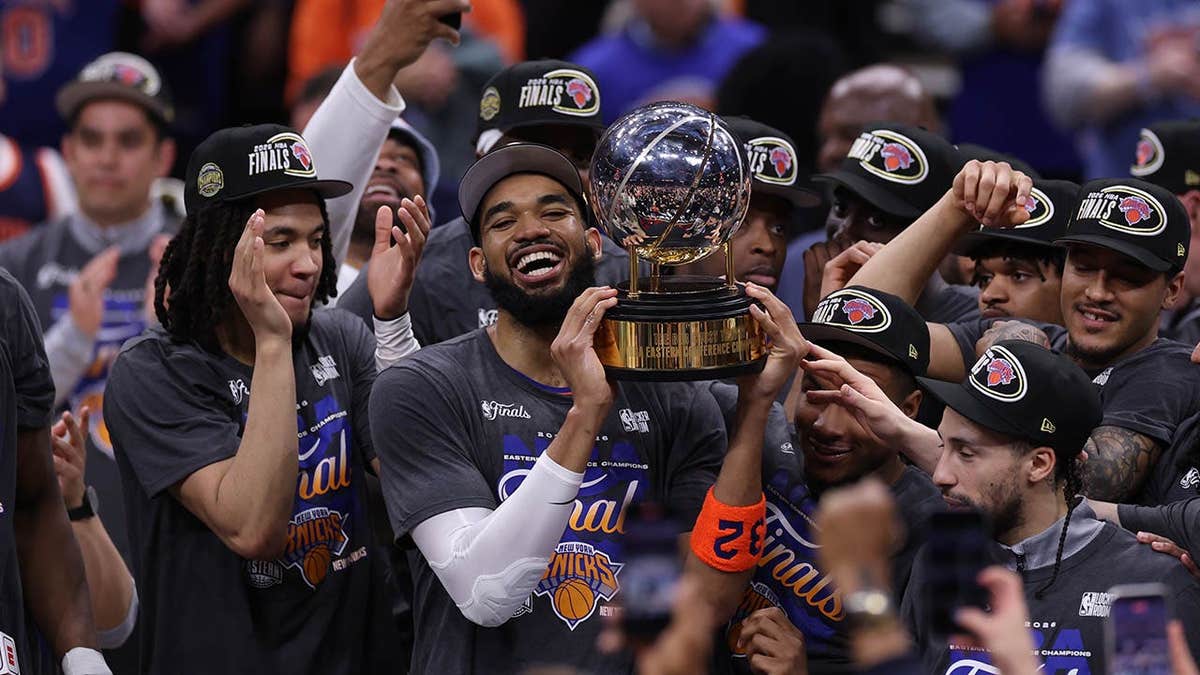 New York Knicks center Karl-Anthony Towns celebrating with teammates on basketball court
