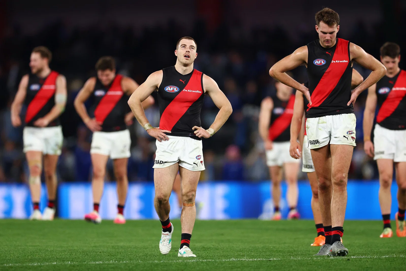 Zach Merrett and Zach Reid of the Bombers look dejected after the round 16 AFL match between North Melbourne Kangaroos and Essendon Bombers at Docklands, on June 28, 2026, in Melbourne, Australia.