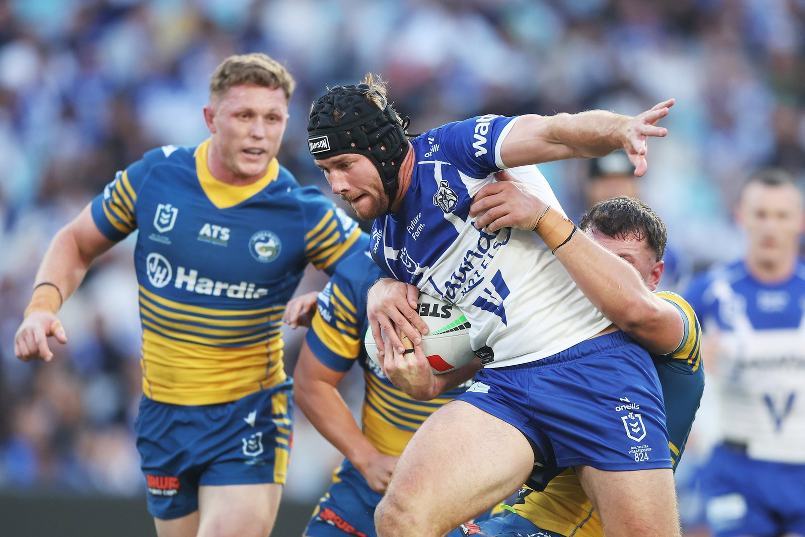A man runs the ball during a rugby league match