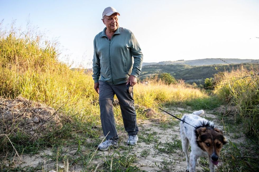 MAN WALKING DOG
