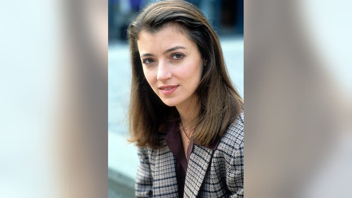 Mia Sara standing in a scene from the film Timecop.
