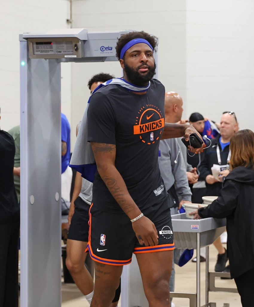 New York Knicks center Mitchell Robinson #23 arriving at the arena for media day, walking through a metal detector.