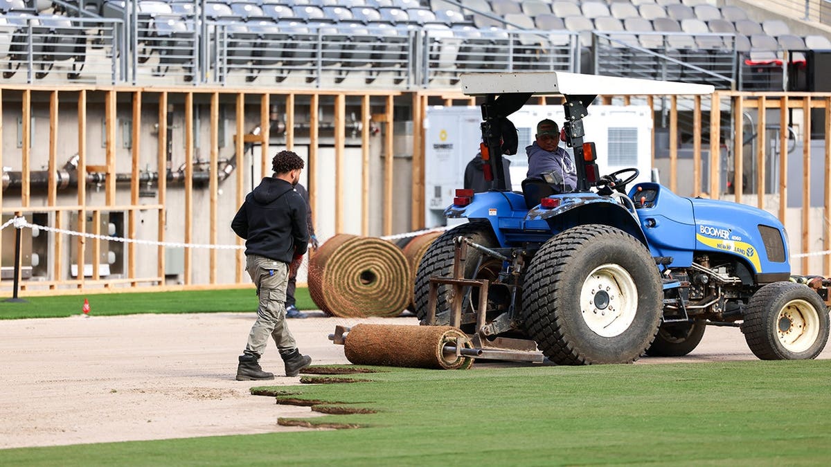 Workers installing pitch at New York New Jersey Stadium in East Rutherford New Jersey