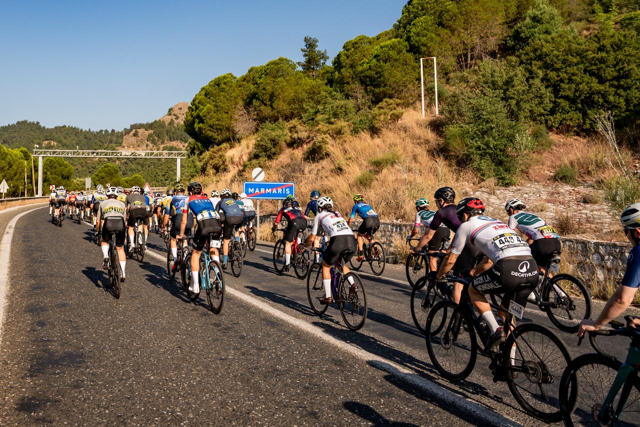 Cyclists ride past a Marmaris sign during L'Etape Marmaris by Tour de France in Mugla, Türkiye. (Photo via L'Etape Marmaris by Tour de France)