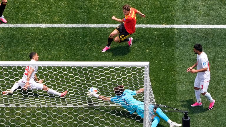 Iran goalkeeper Alireza Beiranvand makes a save from Belgium's Maxim De Cuyper