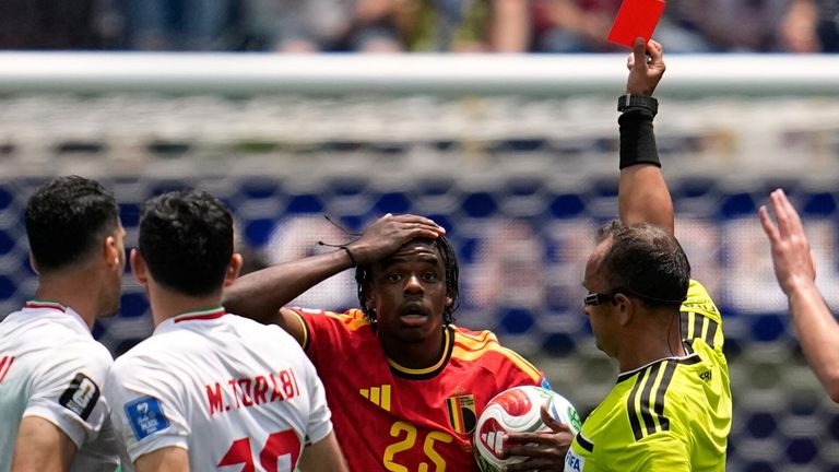 Referee Dario Herrera shows a red card to Belgium's Nathan Ngoy