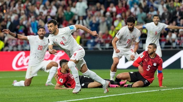 Iran's Shoja Khalilzadeh celebrates after scoring his goal before it was overturned