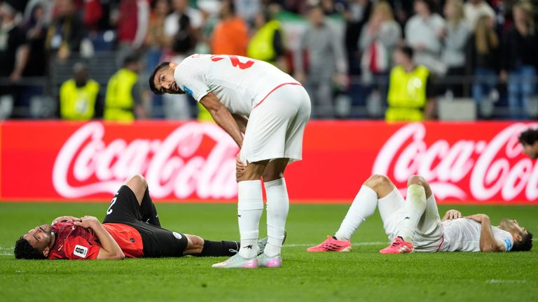 Players of the two teams react at the end of the World Cup Group G match between Egypt and Iran