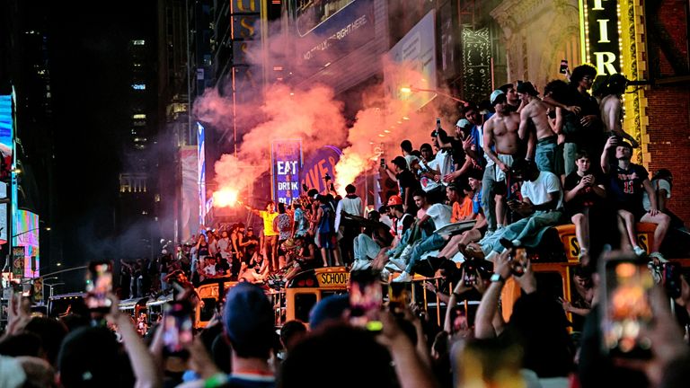Fans mount a school bus near Times Square