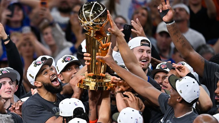 The New York Knicks celebrate with the Larry O'Brien Championship Trophy after defeating the San Antonio Spurs in Game 5 of the NBA Finals