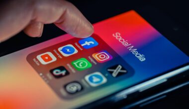 finger pointing to Facebook mobile app displayed on a smartphone screen