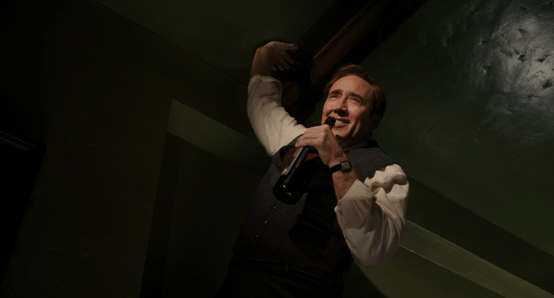 Nicolas Cage's Ben Reilly in Spider-Noir drunk as he sticks to the cieling.