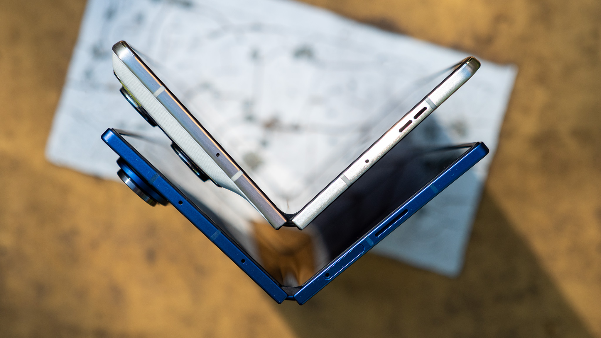 Comparing the thickness of the blue Samsung Galaxy Z Fold 7 with the white Motorola Razr Fold 2026
