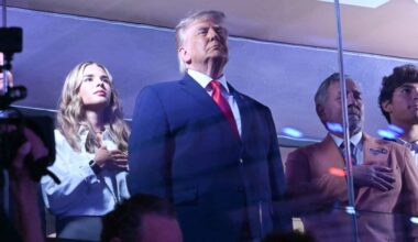 Trump standing in front of a few others in a box at Madison Square Garden