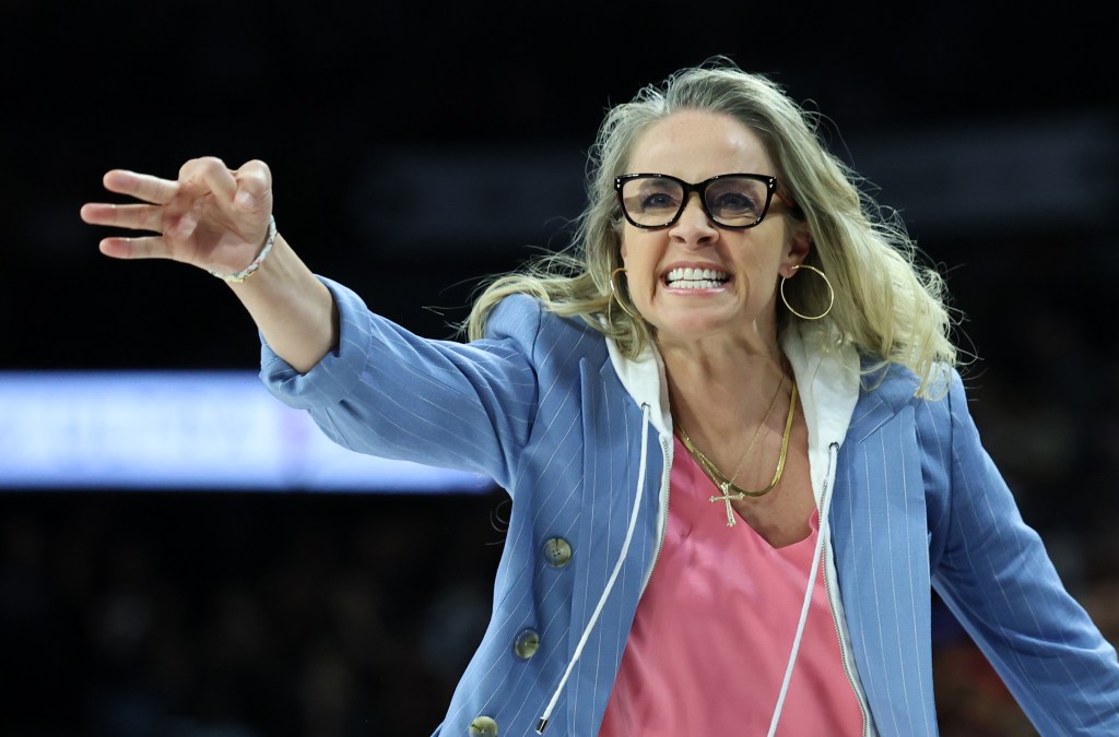 Las Vegas Aces head coach Becky Hammon gestures toward a referee during a game.