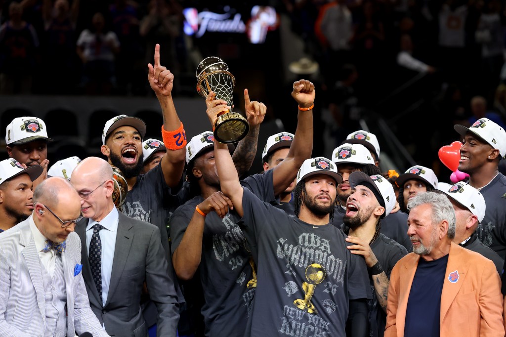 Jalen Brunson holding the Bill Russell NBA Finals Most Valuable Player Award trophy after the New York Knicks win the 2026 NBA Finals.