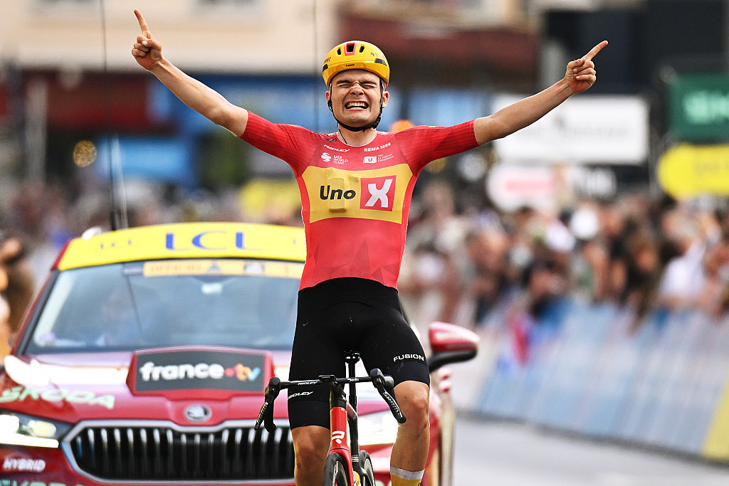 LE PUY-EN-VELAY, FRANCE - JUNE 08: Anthon Charmig of Denmark and Team Uno-X Mobility celebrates at finish line as stage winner during the 78th Tour Auvergne-Rhone-Alpes 2026, Stage 2 a 234.3km stage from Saint-Martin-le-Vinoux to Le Puy-en-Velay 624m / #UCIWT / on June 08, 2026 in Le Puy-en-Velay, France. (Photo by Dario Belingheri/Getty Images)