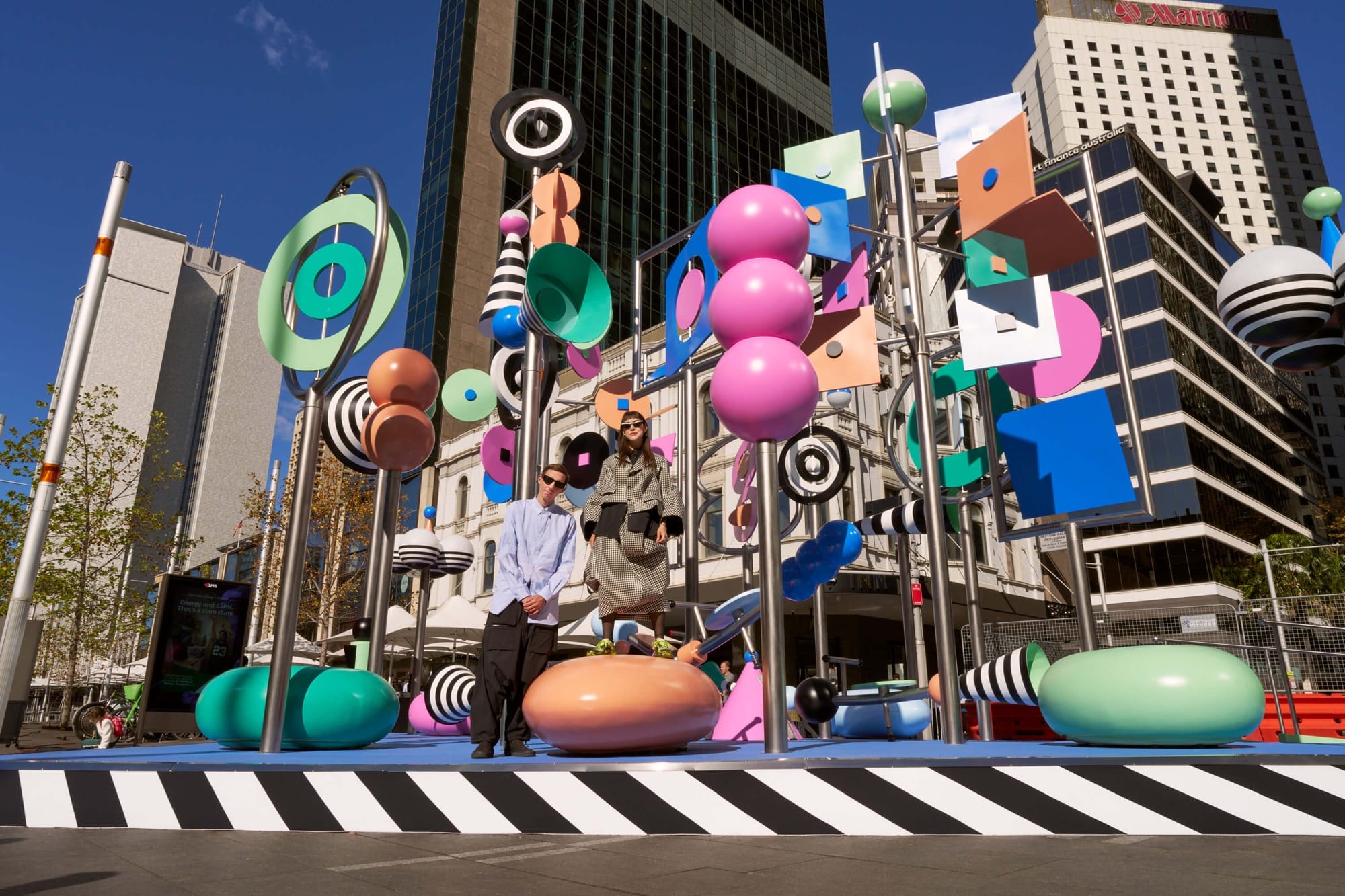 a photo of a colorful outdoor sculpture with twirling shapes by Wade and Leta