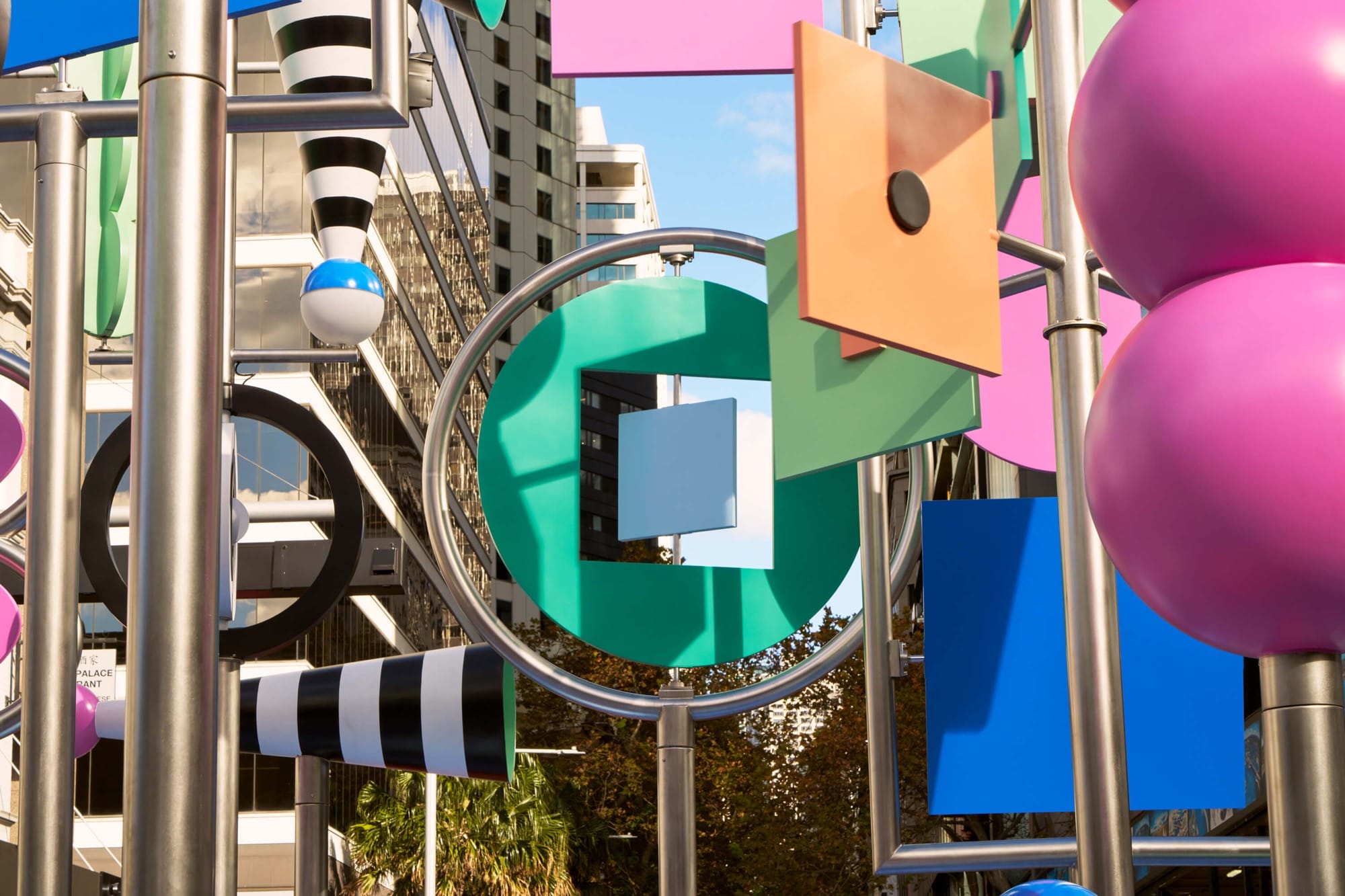 a detail photo of a colorful outdoor sculpture with twirling shapes by Wade and Leta