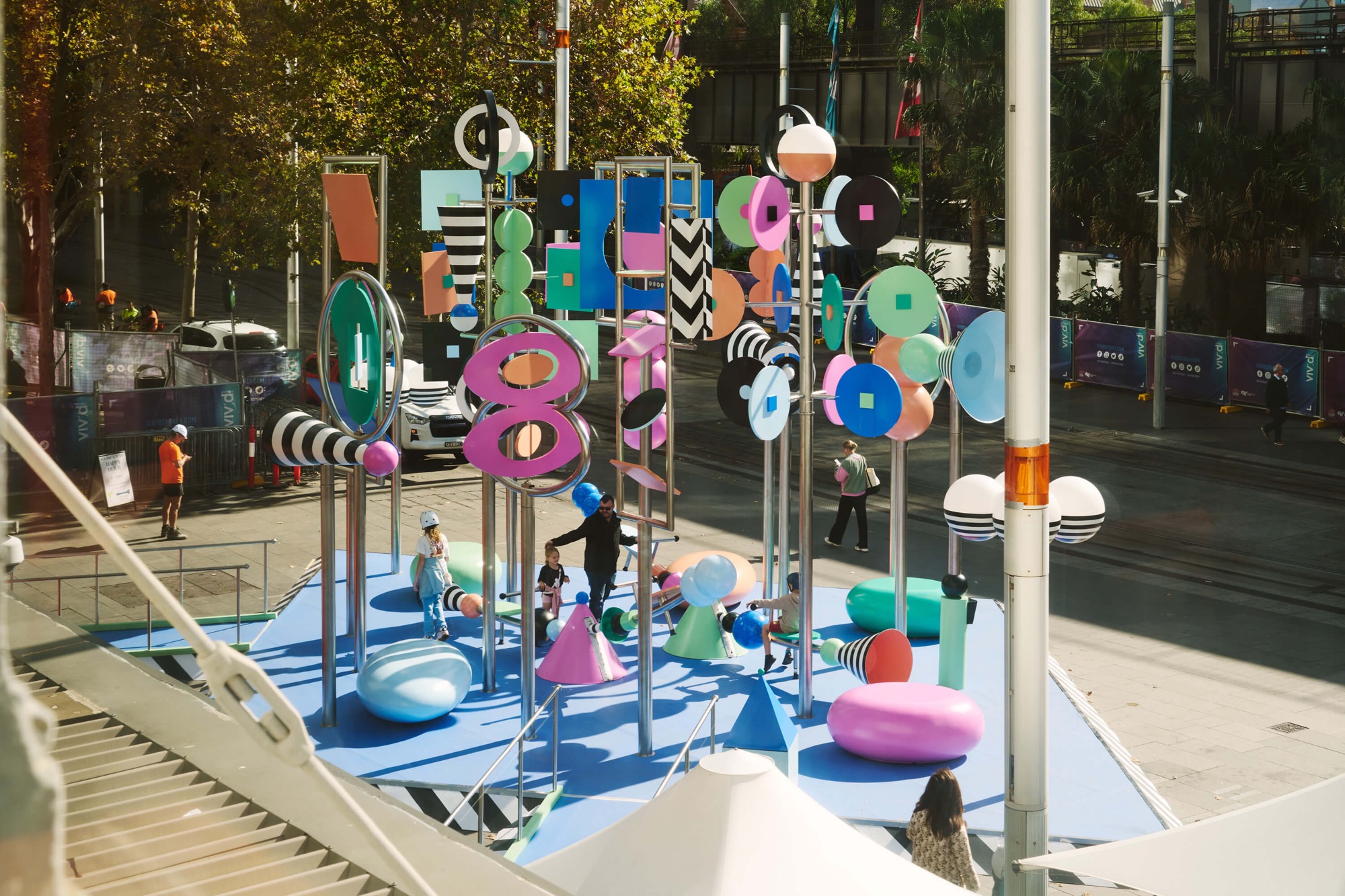 a photo of a colorful outdoor sculpture with twirling shapes by Wade and Leta