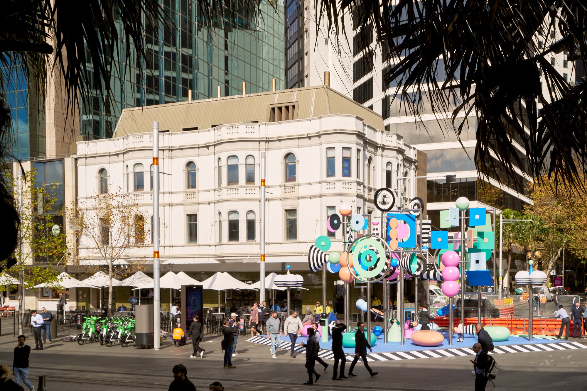 a photo of a colorful outdoor sculpture with twirling shapes by Wade and Leta